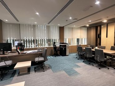 Corporate office interior design in Dubai with ergonomic furniture and glass partitions for a modern workspace.