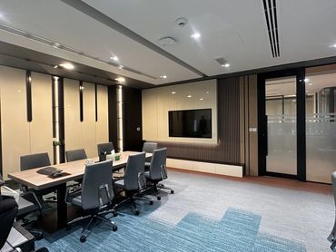 Corporate office interior design in Dubai with ergonomic furniture and glass partitions for a modern workspace.