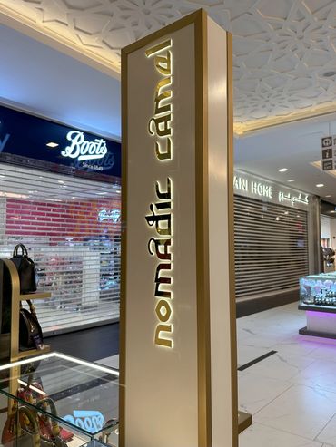 Custom retail kiosk by Fine Tune Interiors in Dubai, designed for showcasing bags and wallets.