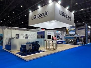indoor exhibition stand in Dubai for Baudouin – bold design showcasing large industrial machines.