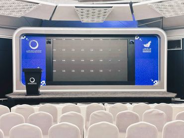 event tent interior in Dubai with stage, big LED screen, and seating setup for innovation showcase.