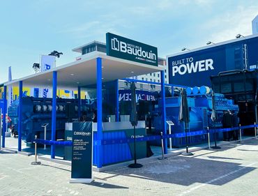Outdoor exhibition stand in Dubai for Baudouin – bold design showcasing large industrial machines.