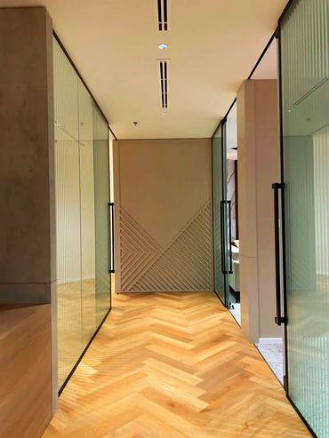 Corporate office interior design in Dubai with glass partitions for a modern design