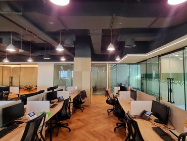 Modern office renovation with bespoke joinery, glass partitions, and functional workspace design.