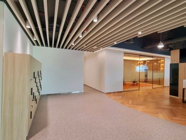 Modern office renovation with bespoke joinery, glass partitions, and functional workspace design.