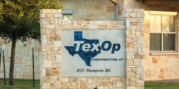 The TexOp Construction, LP sign in front of the company building.