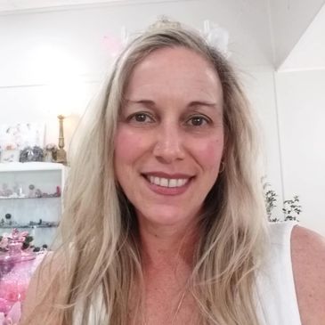 Smiling woman with long blonde hair indoors.