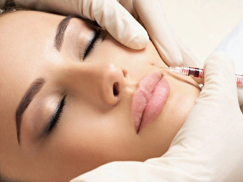 Woman receiving filler treatment