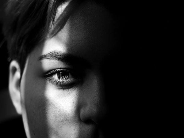 Portrait shot of a person with light leaking on one side of the face