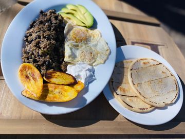 rice and beans with green peppers and onions, avocado, fried sweet plantains, tortillas, sour cream