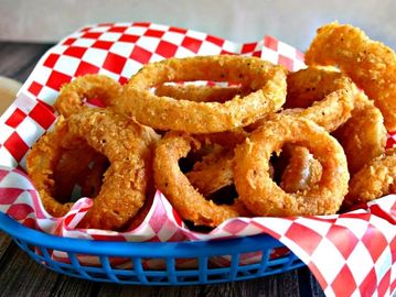 Santini's gourmet crispy extra fancy style onion rings served with a side of Santini's honey Mustard