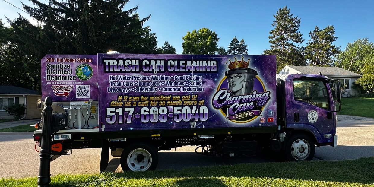 Purple truck advertising trash can cleaning services.
