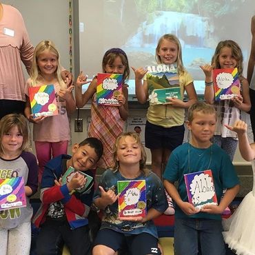 a group of kids holding books