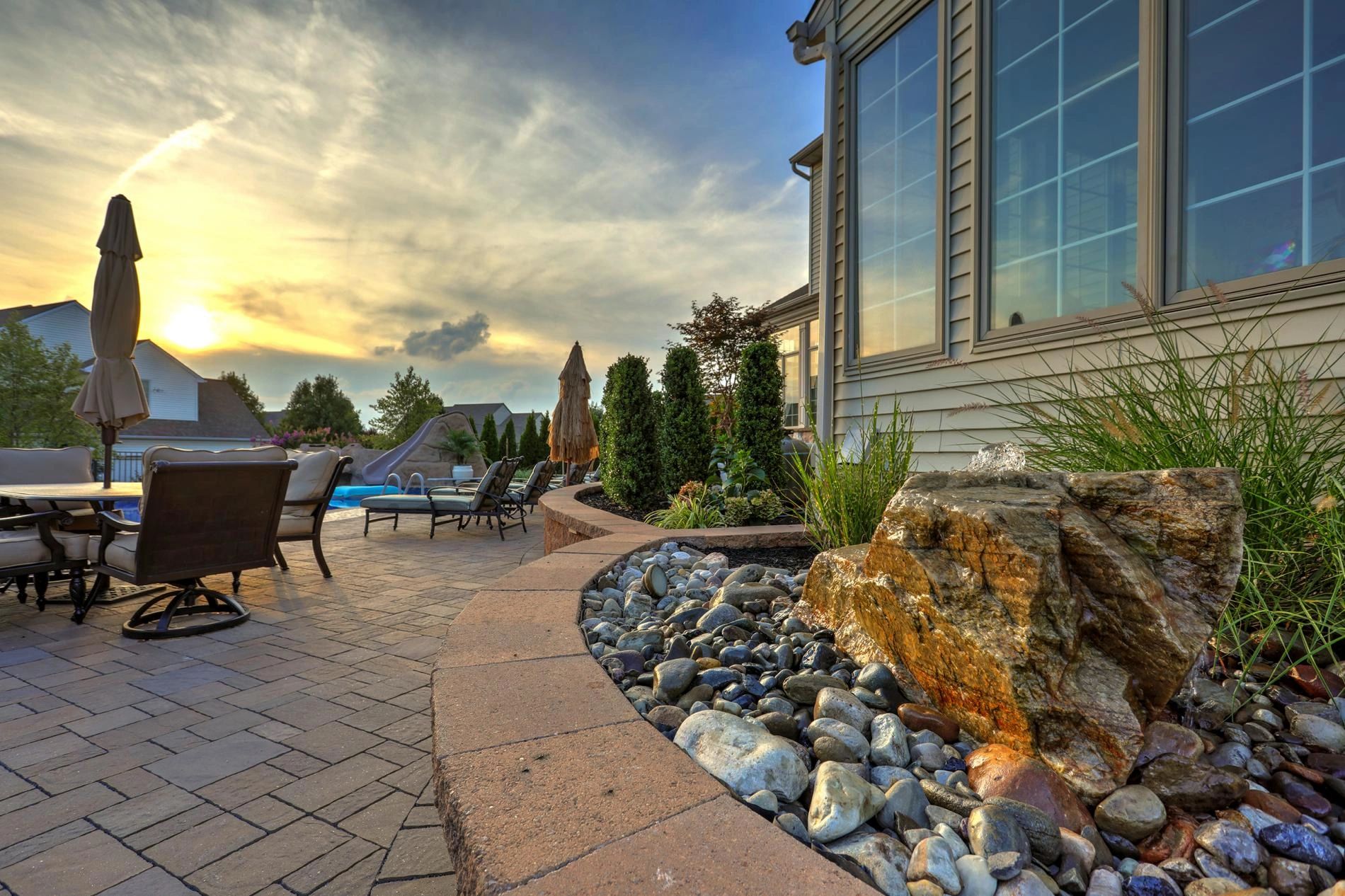 Backyard patio with stone landscaping beds and seating in York County