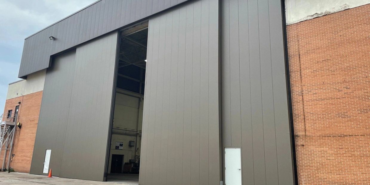 Industrial building with large and small doors.