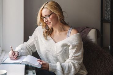 Laura Taylor, Productivity Coach, Full Focus Planner Certified Pro, writing a to-do list