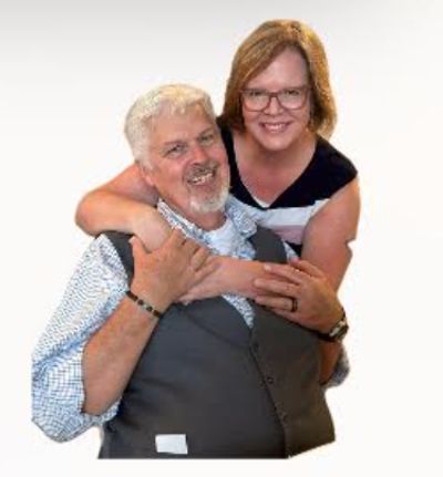 Image of a smiling couple, hugging.