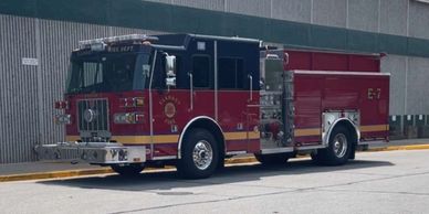 Red fire truck parked near a building.