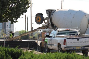 Concrete truck pouring at new gas station.