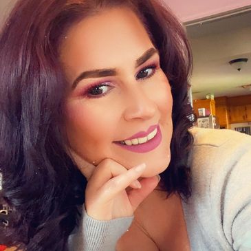 Woman with dark hair smiling warmly.