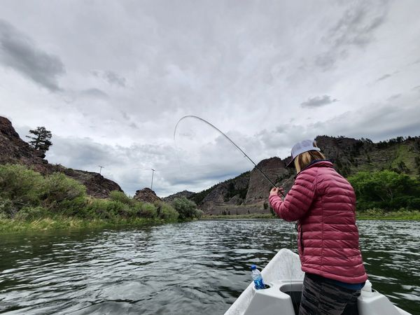 Woman with bent rod near Craig Montana while using a Montana Fly Fishing Guide