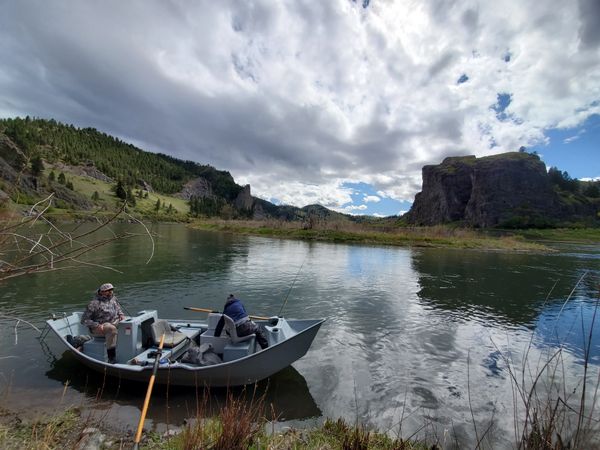 Craig Montana Missouri River fly fishing in a drift boat anchored near the bank with mountains