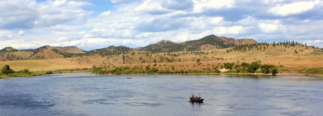 Missouri River Fly Fishing Guides in a wooden drift boat near Craig, Montana