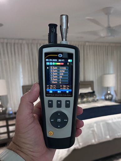 Home Enviro Licensed Mold Inspector conducting an air quality pretest using a particle counter.