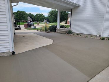 Newly poured concrete driveway next to an older section.