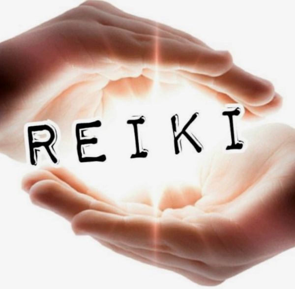 cupped hands holding a symbolic ball of light with the word REIKI in the centre