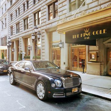 On Manhattan's East 55th, a Rolls-Royce is parked in front of The King Cole Bar.