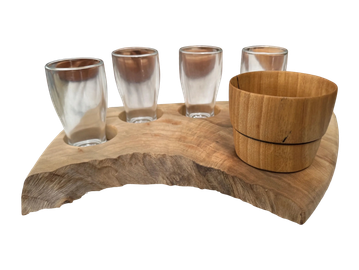 Wooden shot glass holder with four glasses and a wooden cup.