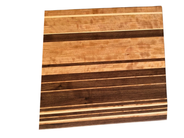 Wooden cutting board with alternating light and dark stripes.