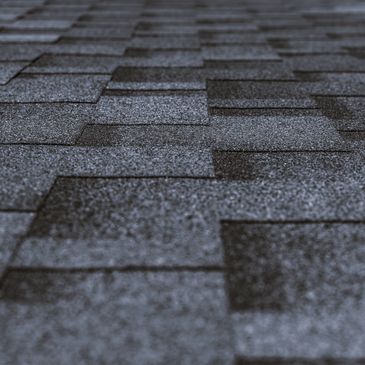 Close-up of dark asphalt roof shingles.