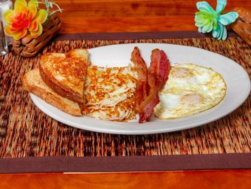 A classic breakfast plate with eggs, bacon, hashbrowns, and toast.
