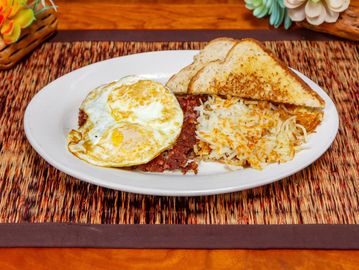Eggs, hash browns, toast, and corned beef hash breakfast.
