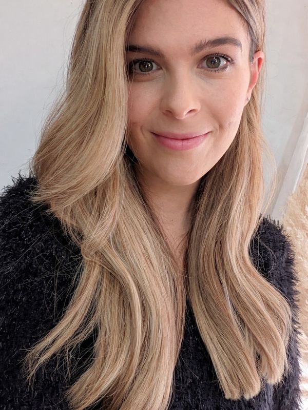 Smiling woman with long blonde hair and a black sweater.