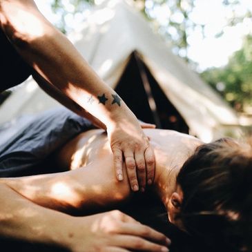Woman having a deep tissue massage in an outdoor nature setting