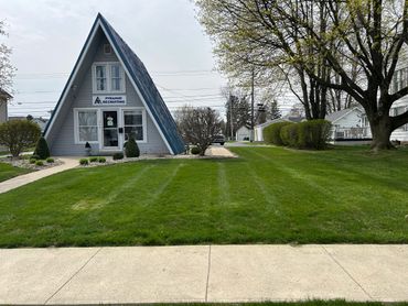 A-frame building with Pyramid Recruiting sign and well-kept lawn.