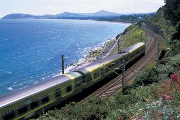 A train speeding along a coastal railway track.