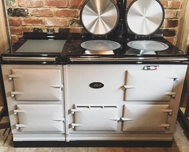 an aga with the hob lids open after an oven cleaning service