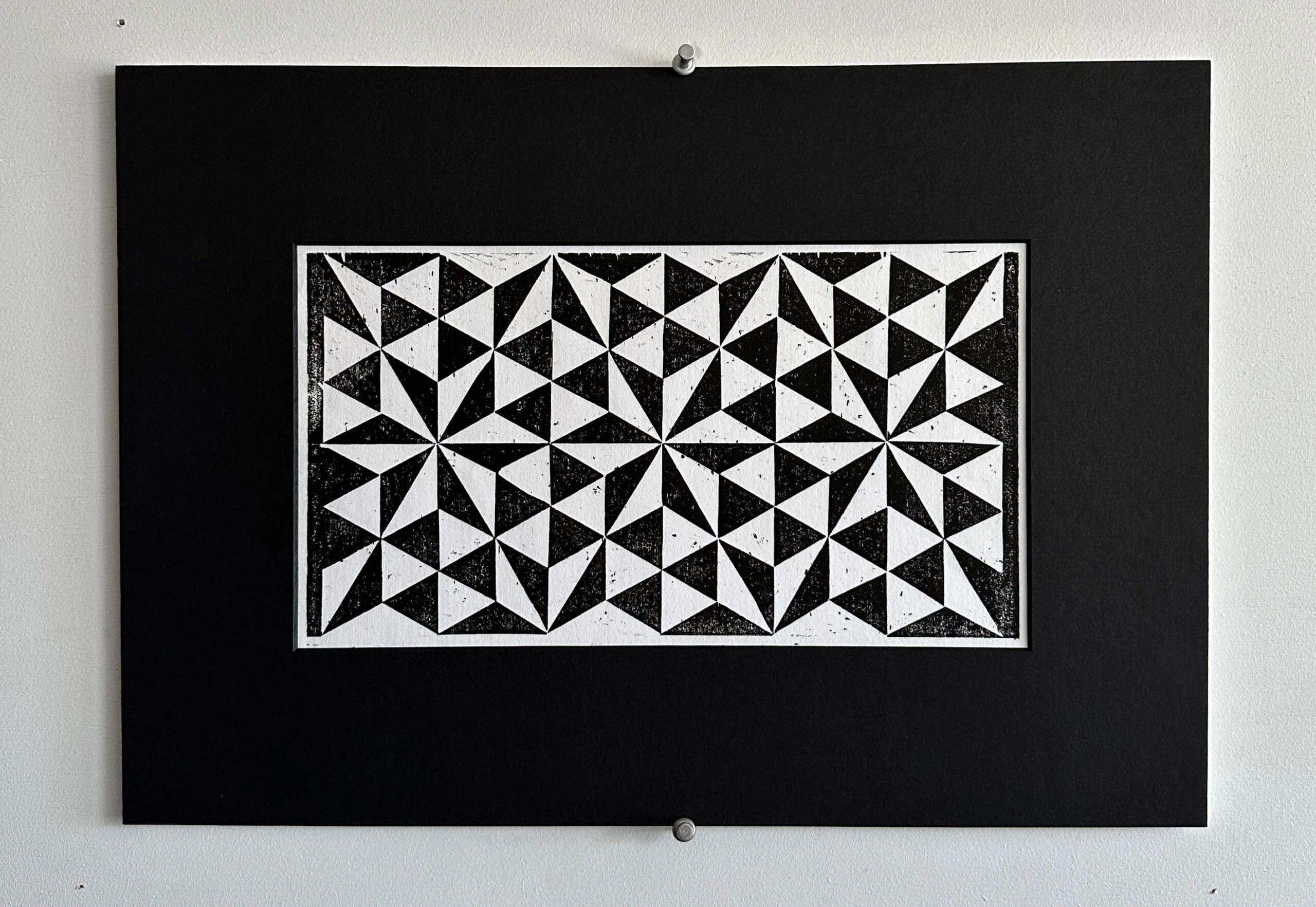 Black and white geometric triangle pattern artwork.