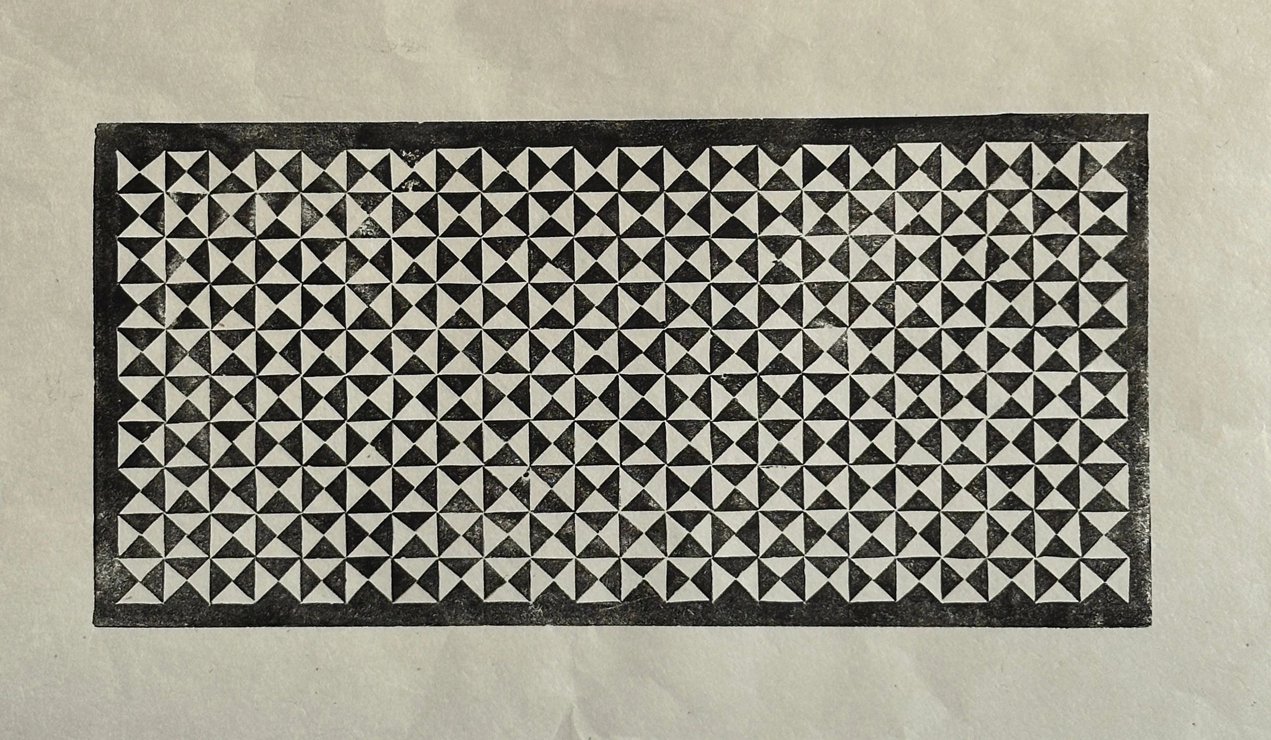 Black-and-white geometric pattern of triangles in a grid.
