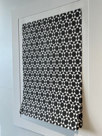 Black and white geometric triangle pattern artwork.
