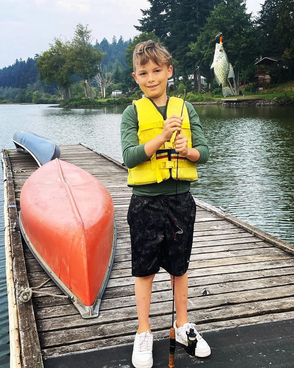 A boy caught a fish at Silver Lake Resort, WA.