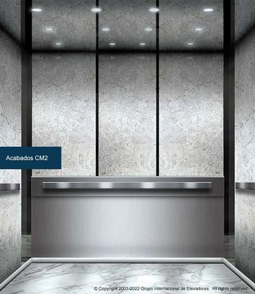 Vista frontal de un elevador para pasajeros ASME A17.1 CSA B44 de mármol y acero inoxidable