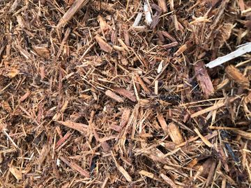 This is shredded cypress mulch ground and shred into a medium mixture. Golden colored natural wood. 