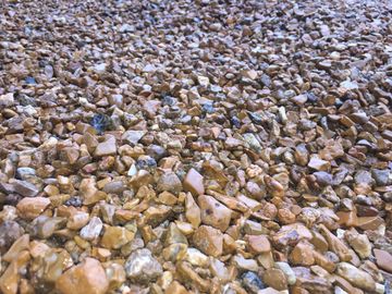 This gravel is Meramec. Made of natural colors that vary in tone. They are small smooth stones.