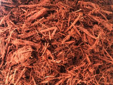 This is all natural hardwood that was ground, shredded and dyed a rich red. Red dyed hardwood mulch 