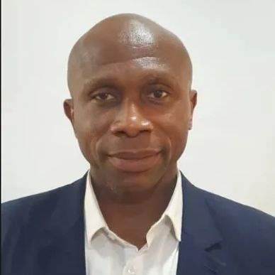 Portrait of a man in a suit with a neutral expression.